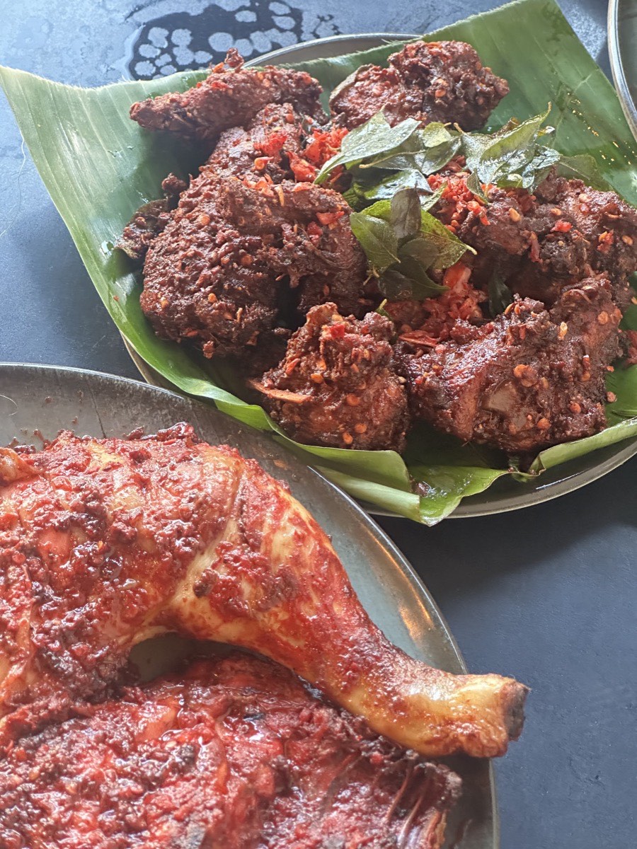 Vizhanjam-style chicken fry in a fiery red masala on a banana leaf, with a second chilli-glazed chicken plate at Chai Kadai