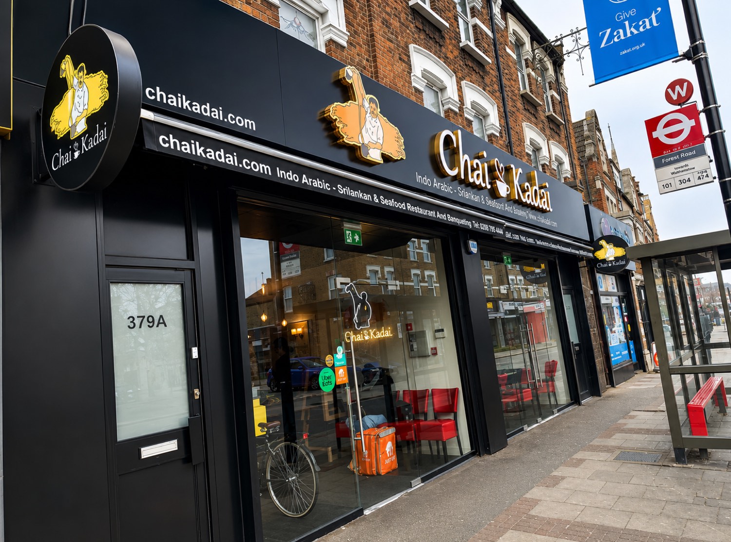 The Chai Kadai shopfront on High Street North, East Ham — black and gold fascia with the chai-puller logo